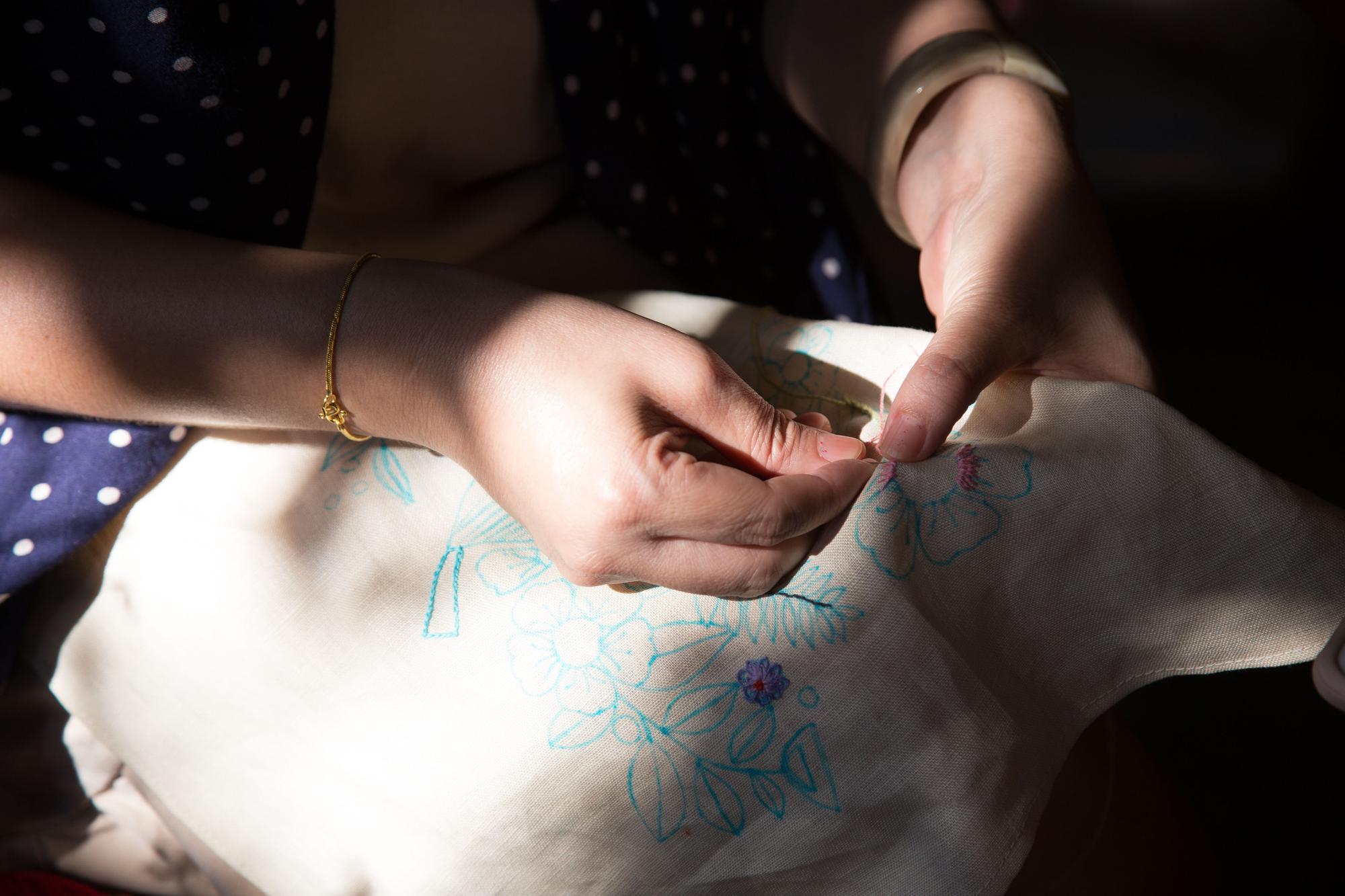 Workshop hands stitching detailed embroidery
