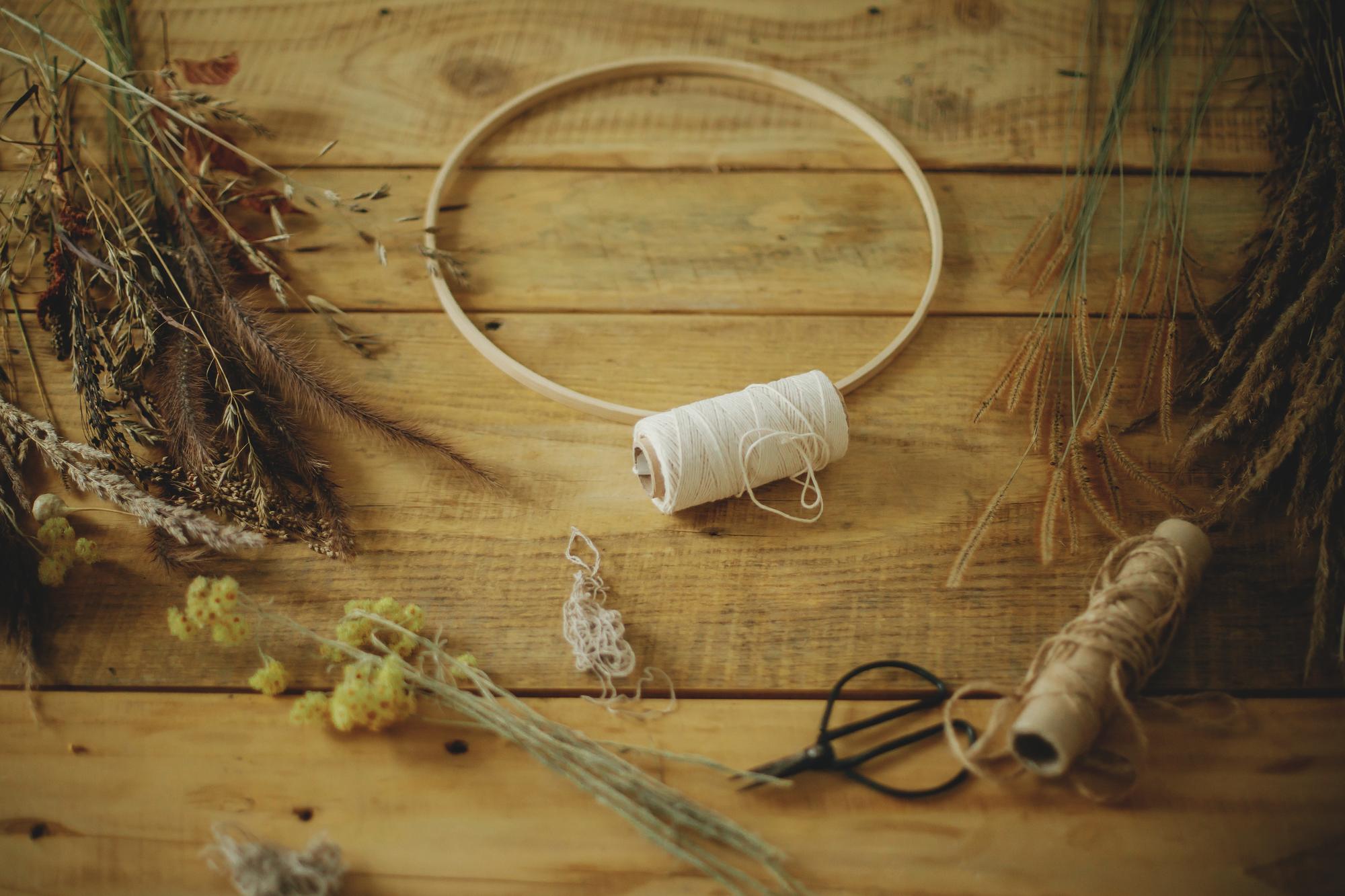 Studio table with threads and embroidery hoop