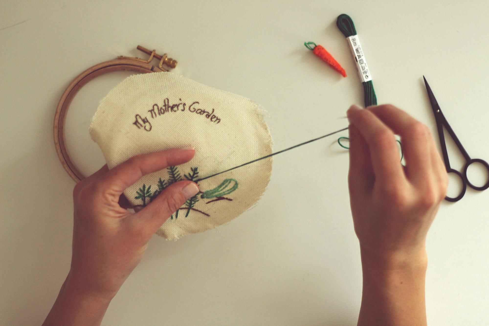 Artist holding embroidered patch